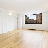 a view of a room with wooden floor and window