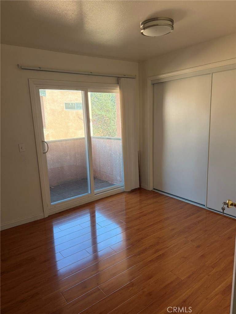 11829 Ferris Road, Unit E El Monte, CA 91732 - Photo 3 of 10 a view of an empty room with wooden floor and a window