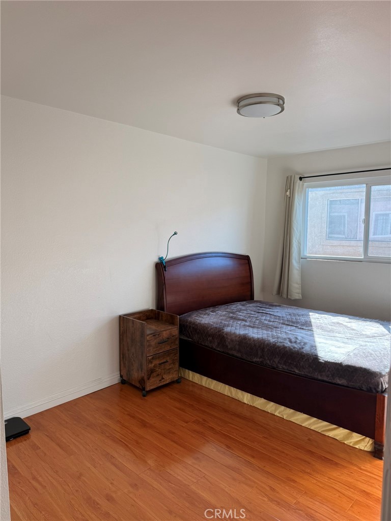 11829 Ferris Road, Unit E El Monte, CA 91732 - Photo 4 of 10 a bedroom with a bed and window