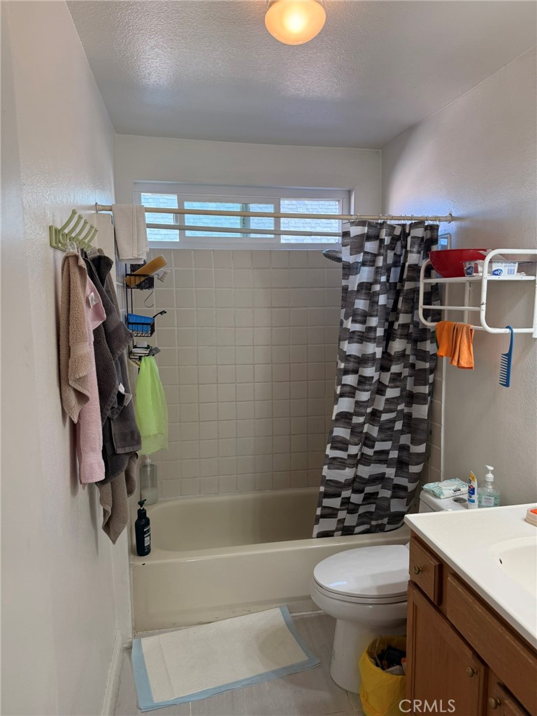 11829 Ferris Road, Unit E El Monte, CA 91732 - Photo 5 of 10 a bathroom with a sink a toilet and shower