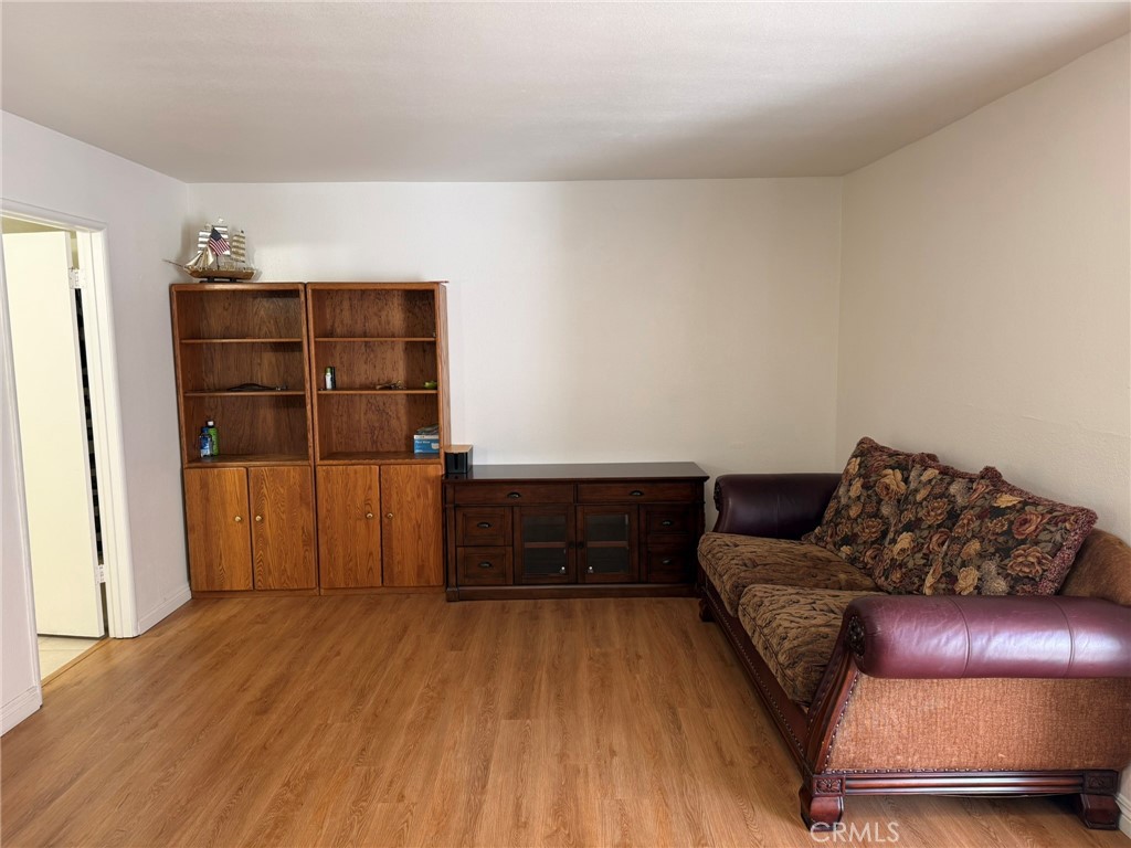 11829 Ferris Road, Unit E El Monte, CA 91732 - Photo 7 of 10 a living room with furniture and wooden floor