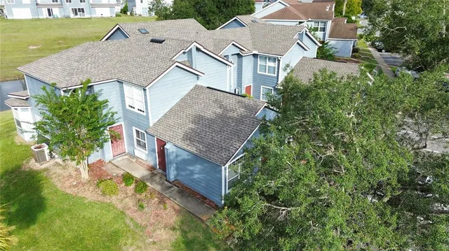 an aerial view of houses with yard