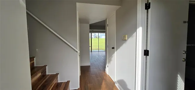 a view of entryway and hall with wooden floor
