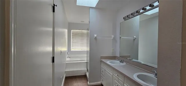 a bathroom with a sink and mirror with toilet