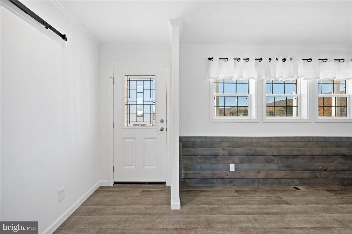 1412 Heytesbury Road Walnutport, PA 18088 - Photo 12 of 39 a view of an empty room with wooden floor and windows