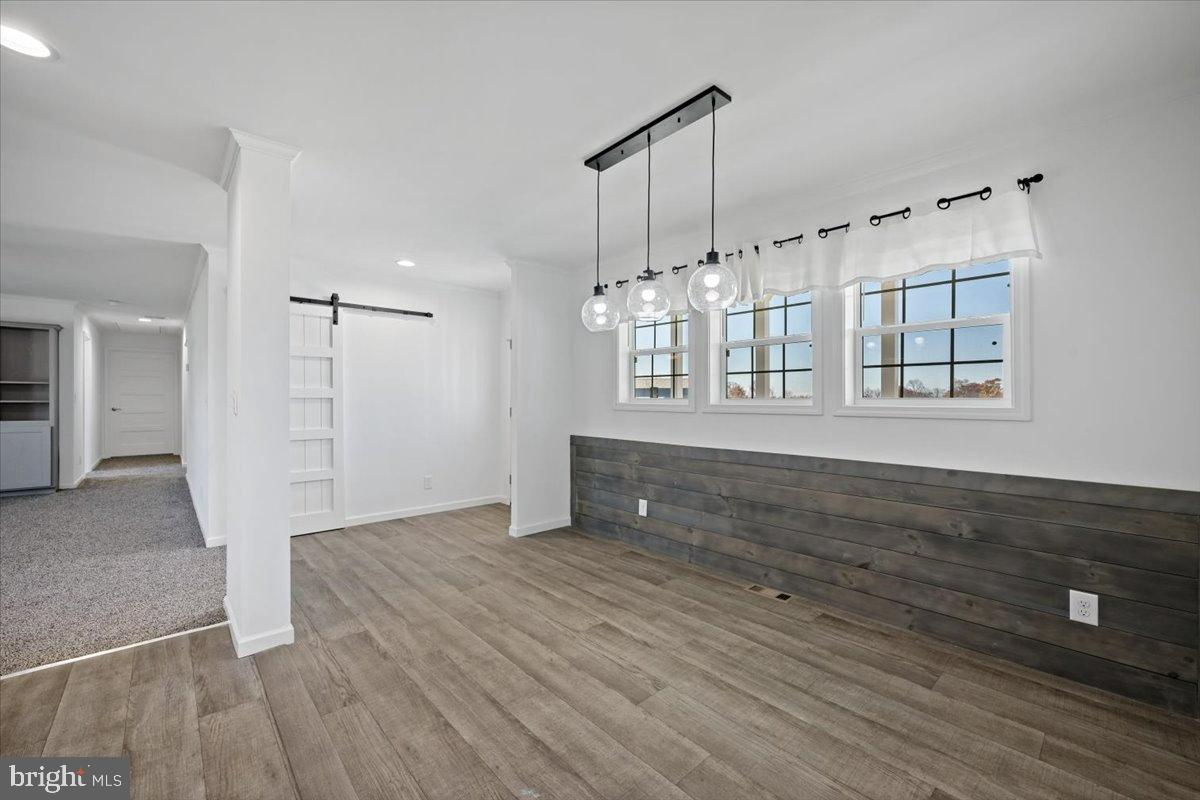 1412 Heytesbury Road Walnutport, PA 18088 - Photo 15 of 39 a view of an empty room with wooden floor and a window