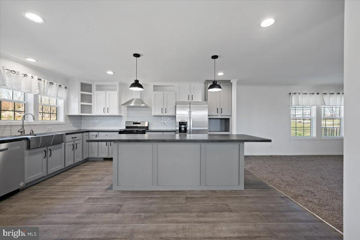 1412 Heytesbury Road Walnutport, PA 18088 - Photo 17 of 39 a large kitchen with granite countertop a white stove top oven and white cabinets