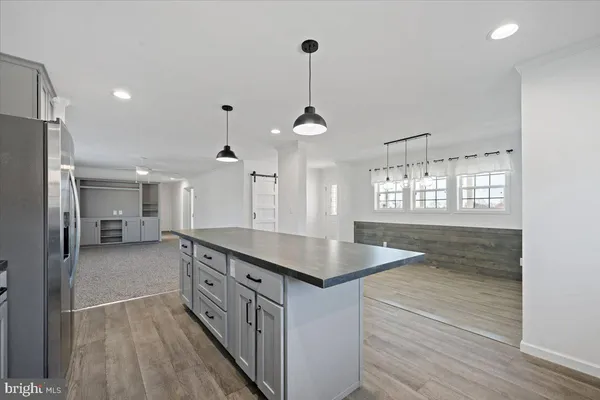 a kitchen with counter top space and wooden floor