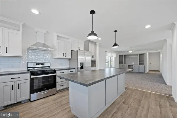 a kitchen with stainless steel appliances granite countertop a stove and a sink