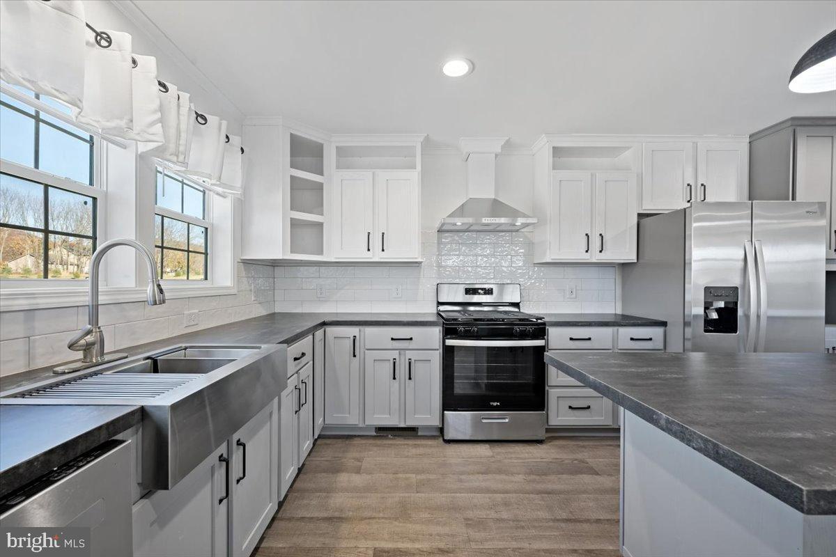 1412 Heytesbury Road Walnutport, PA 18088 - Photo 23 of 39 a kitchen with stainless steel appliances granite countertop a sink stove and refrigerator