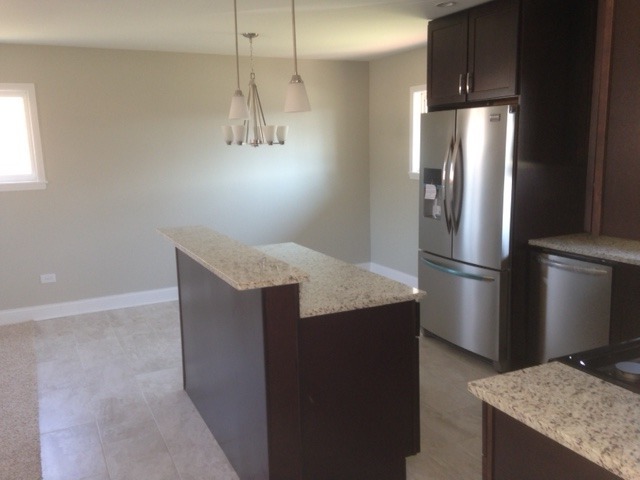 193 South Pinecrest Road Bolingbrook, IL 60440 - Photo 6 of 21 a kitchen with stainless steel appliances granite countertop a refrigerator a sink and a stove