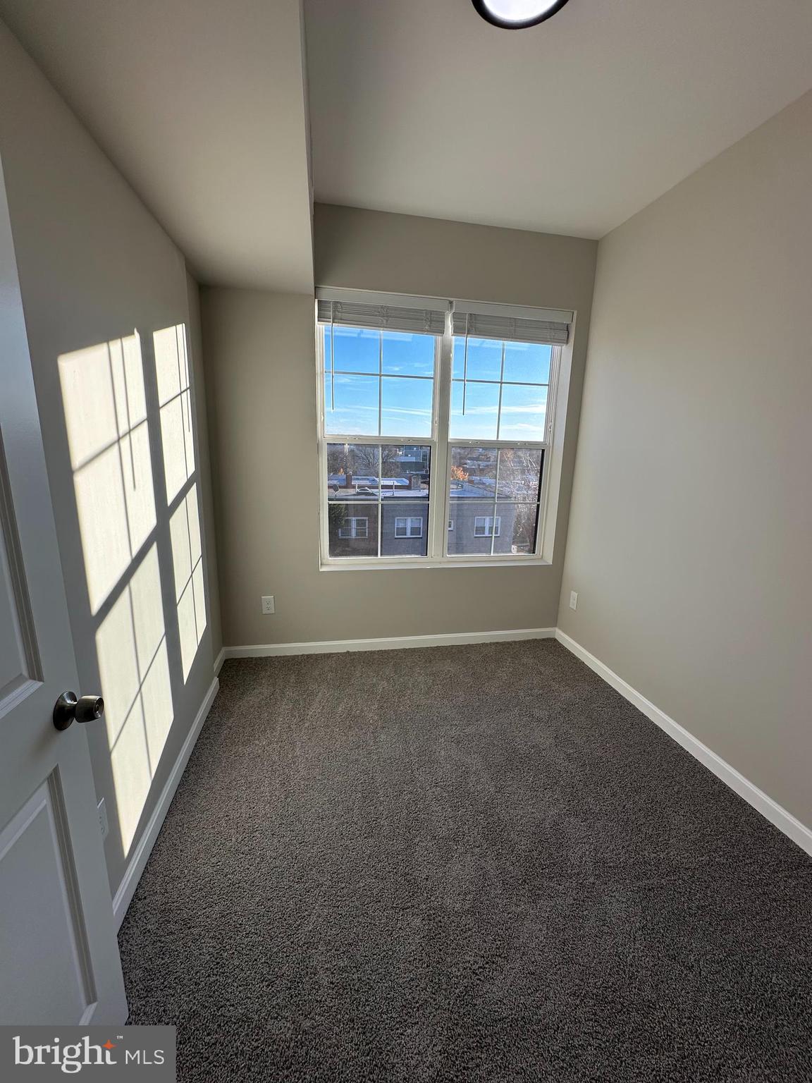 1812 H Place Northeast, Unit B02 Washington, DC 20002 - Photo 7 of 13 an empty room with windows