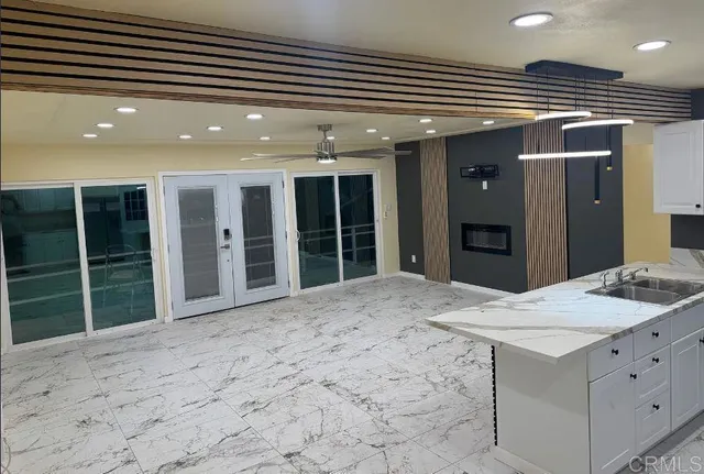 a view of a hall with kitchen and sink