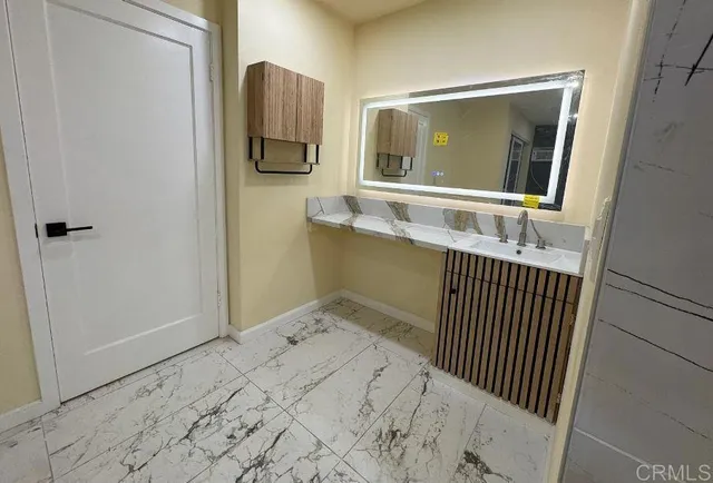 a bathroom with a sink and mirror