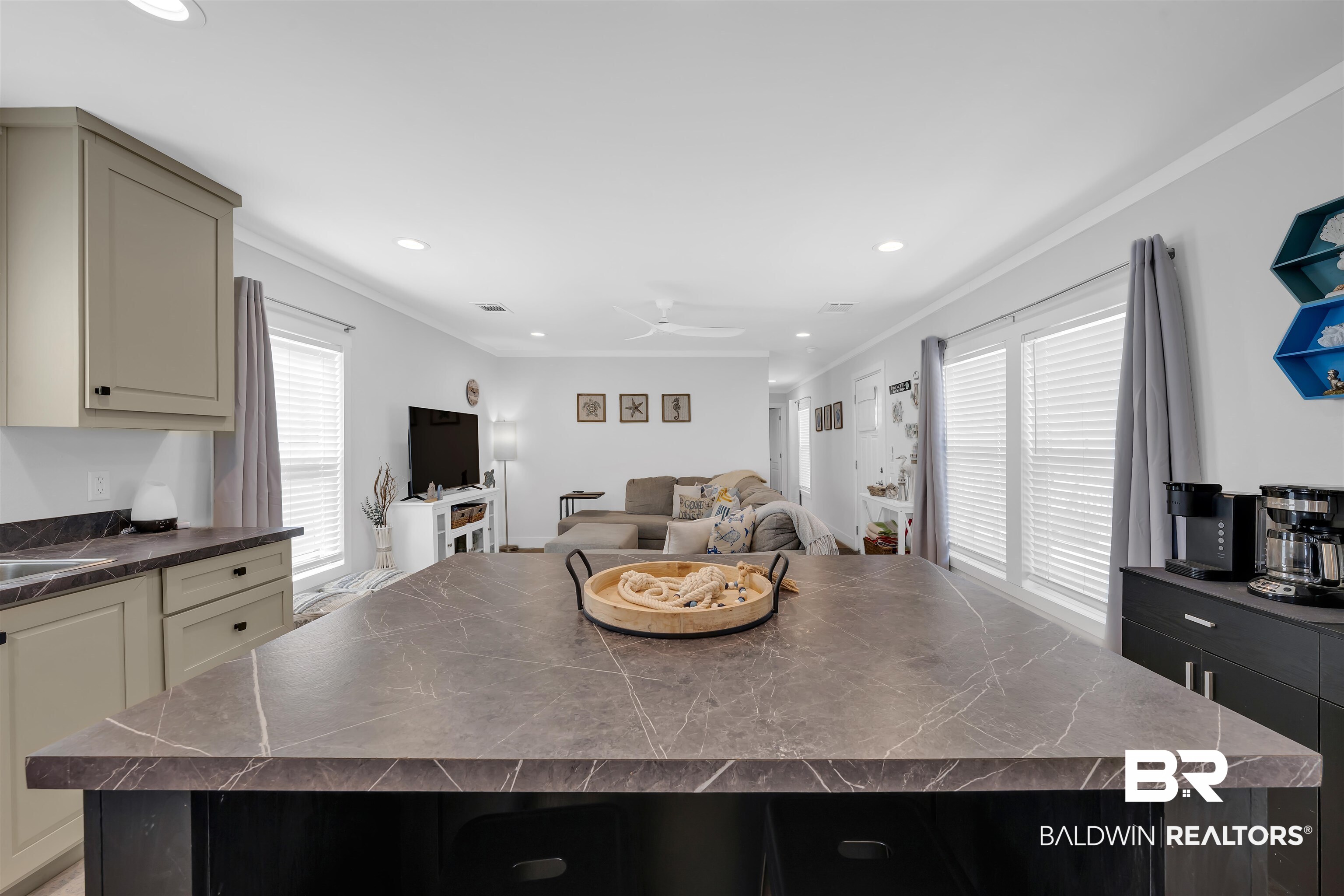 16707 Fort Morgan Road Gulf Shores, AL 36542 - Photo 22 of 22 Kitchen with a center island, open floor plan, recessed lighting, ornamental molding, and a ceiling fan