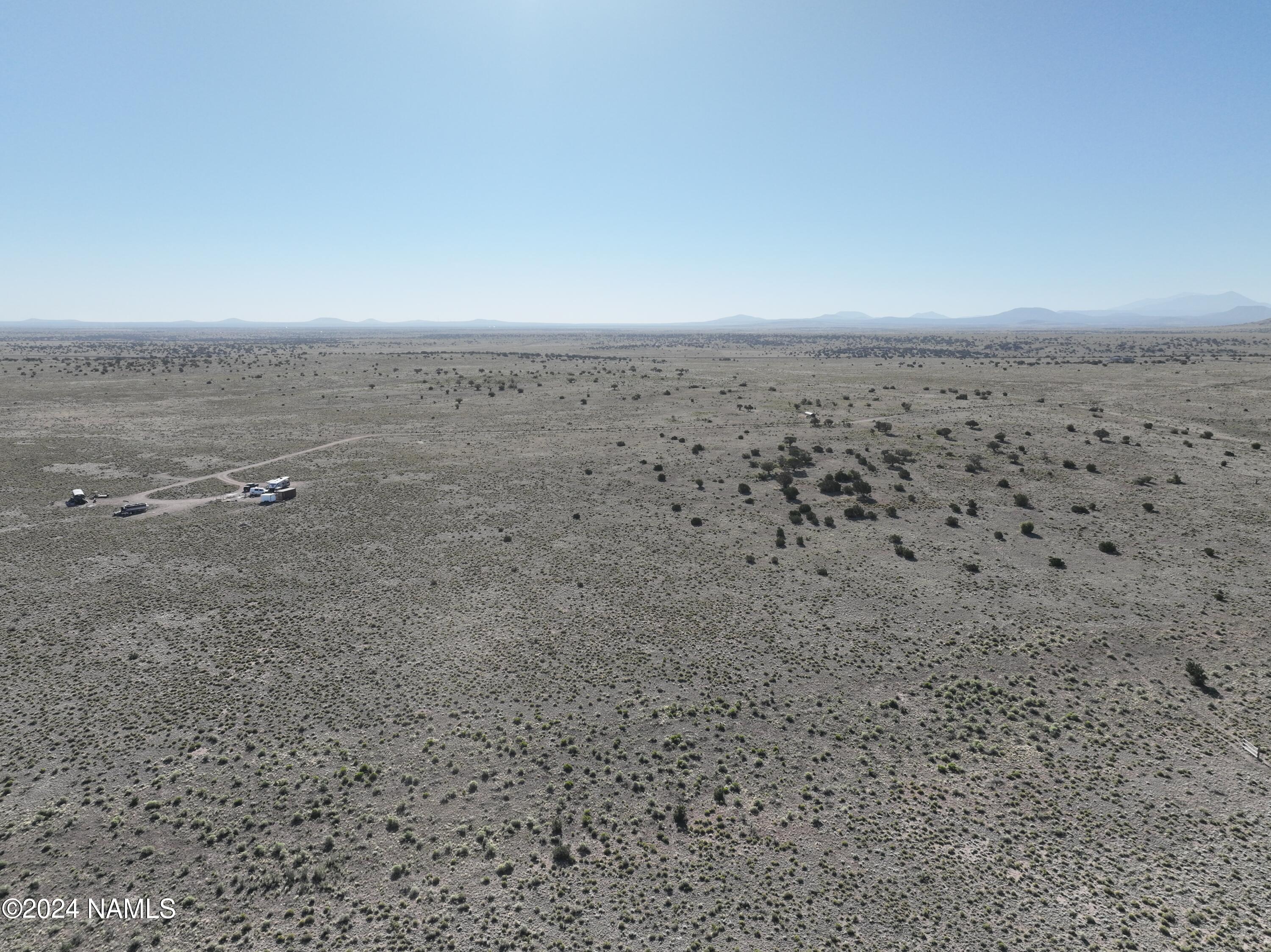 5892 South Quivero Road Williams, AZ 86046 - Photo 19 of 26 a view of a dry yard with wooden fence