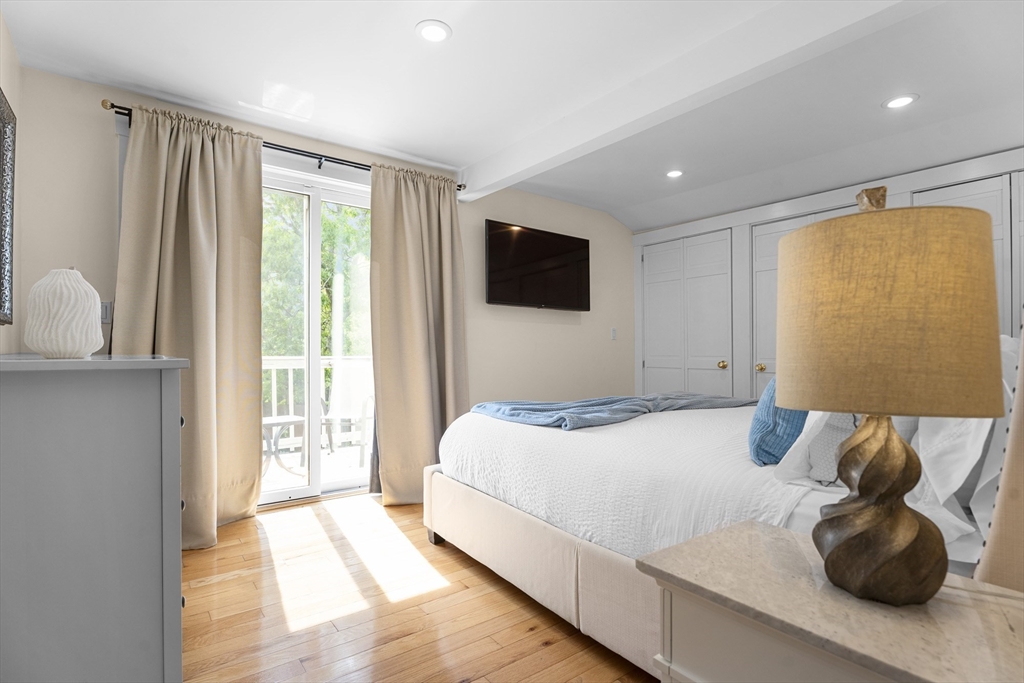 4 Hye Lane Edgartown, MA 02539 - Photo 11 of 41 a bedroom with a large bed and a large window