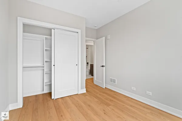 a view of an empty room and wooden floor
