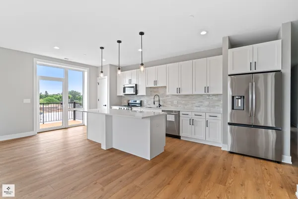 a kitchen with white cabinets and white appliances