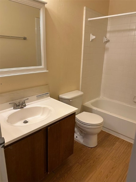 1501 Stallings Drive, Unit 52 College Station, TX 77840 - Photo 12 of 15 Full bathroom featuring dark wood finished floors, vanity, and shower combination