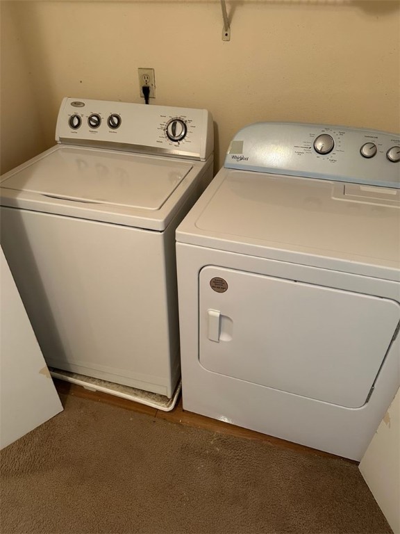 1501 Stallings Drive, Unit 52 College Station, TX 77840 - Photo 13 of 15 Laundry area with washer and dryer and dark carpet