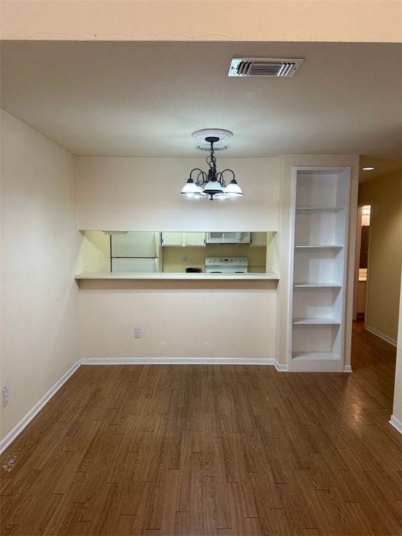 1501 Stallings Drive, Unit 52 College Station, TX 77840 - Photo 4 of 15 Unfurnished dining area featuring dark wood-type flooring and built in shelves