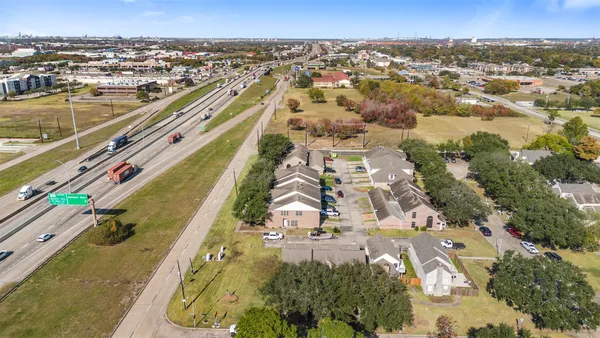 an aerial view of residential houses with outdoor space