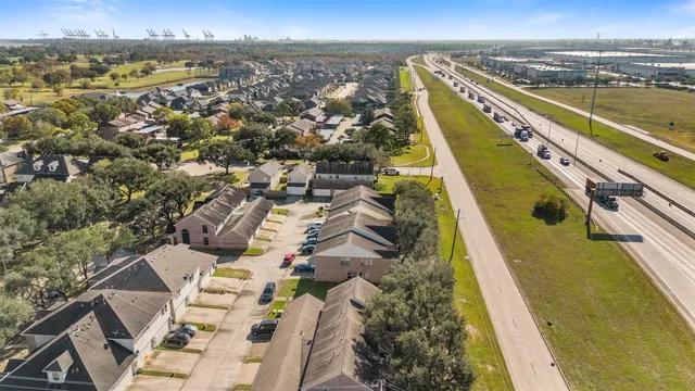 an aerial view of residential houses with outdoor space