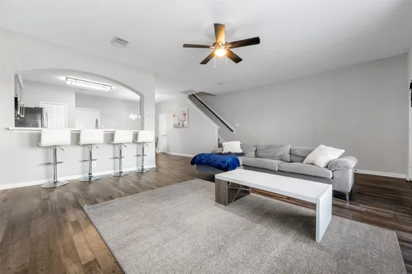 a living room with furniture and a ceiling fan