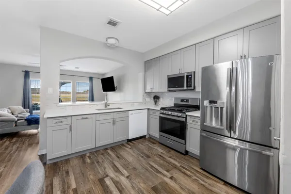 a kitchen with a refrigerator stove and sink