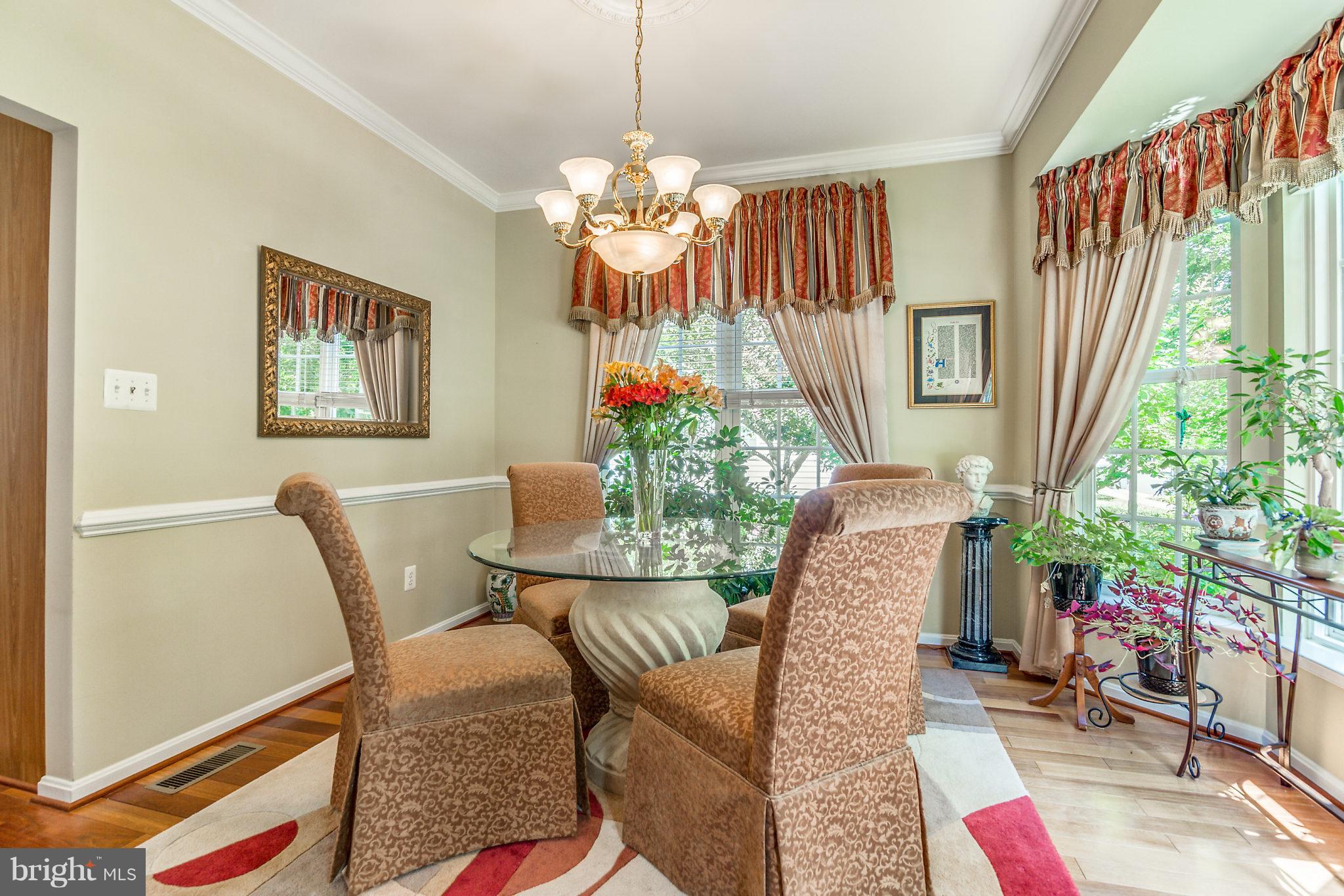 24806 Prairie Grass Drive Aldie, VA 20105 - Photo 11 of 30 a view of a dining room with furniture and a chandelier