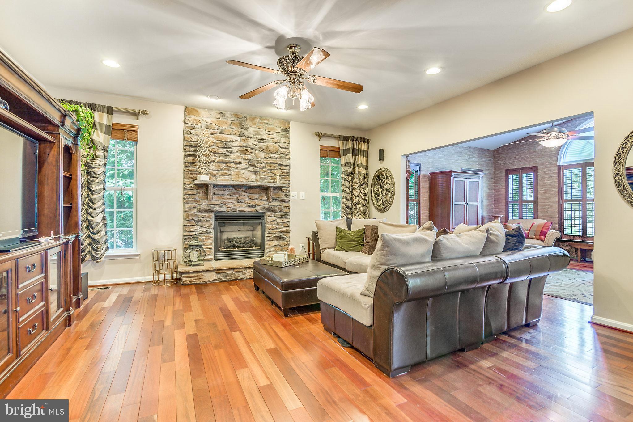 24806 Prairie Grass Drive Aldie, VA 20105 - Photo 4 of 30 a living room with furniture and a fireplace
