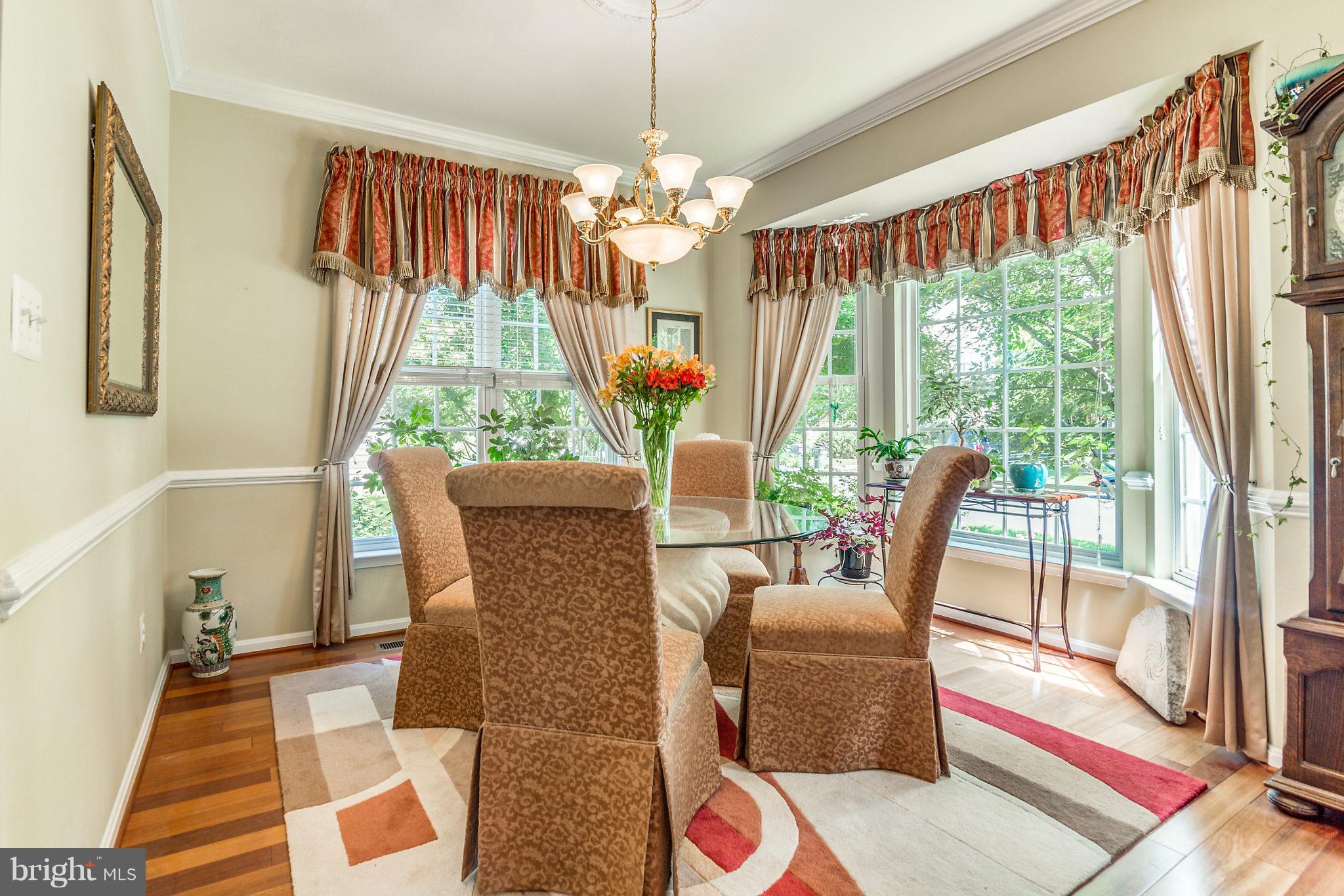 24806 Prairie Grass Drive Aldie, VA 20105 - Photo 10 of 30 a view of a dining room with furniture wooden floor and chandelier