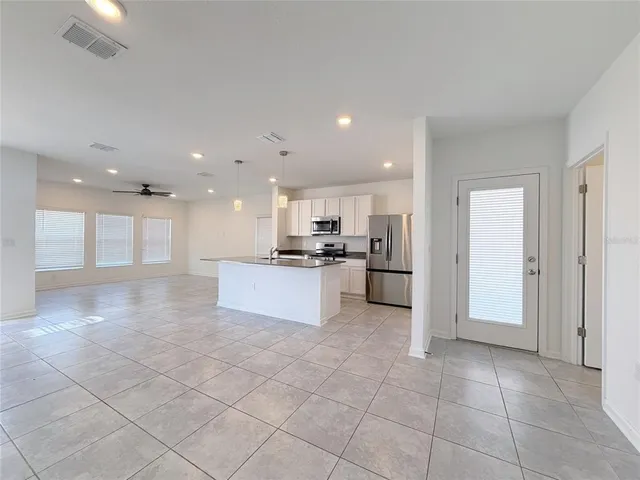 a view of a livingroom with a ceiling fan and window