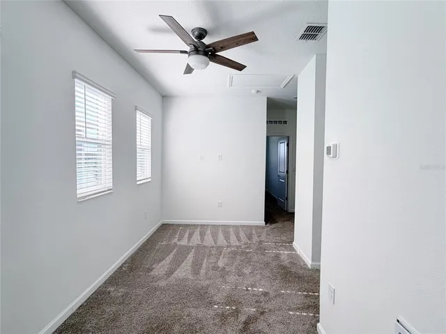 a bathroom with a bathtub shower sink vanity mirror and toilet