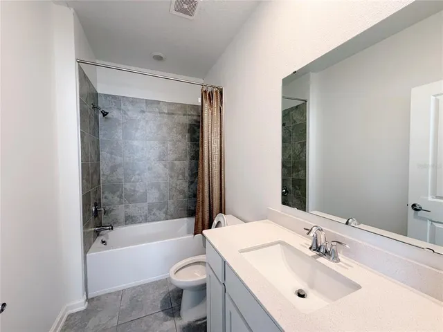 a bathroom with a sink toilet and mirror