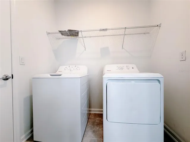 a large white kitchen with cabinets