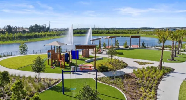 an aerial view of a house with a garden and lake view