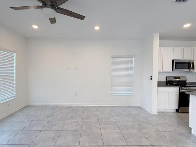 a view of an empty room with a kitchen