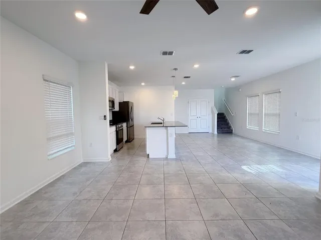 a kitchen with a sink a counter top space appliances and cabinets