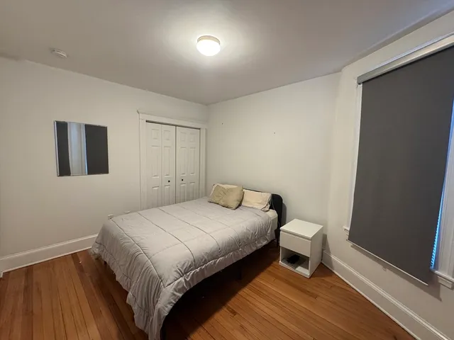 a bedroom with a bed and a table