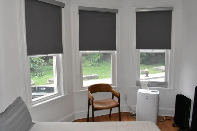 a view of a livingroom with lounge chair and a window