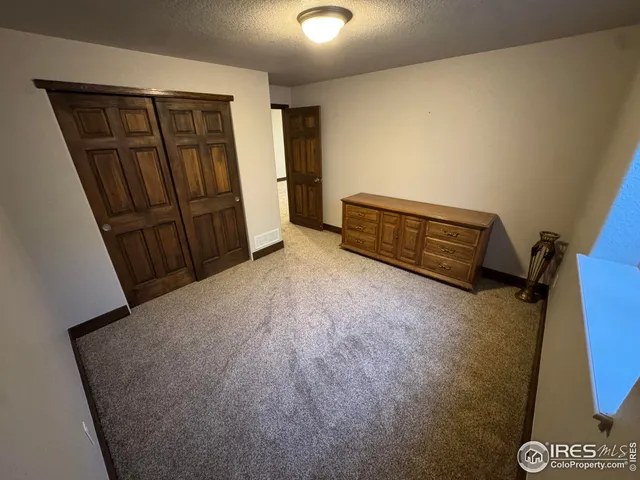 a view of an empty room with wooden door