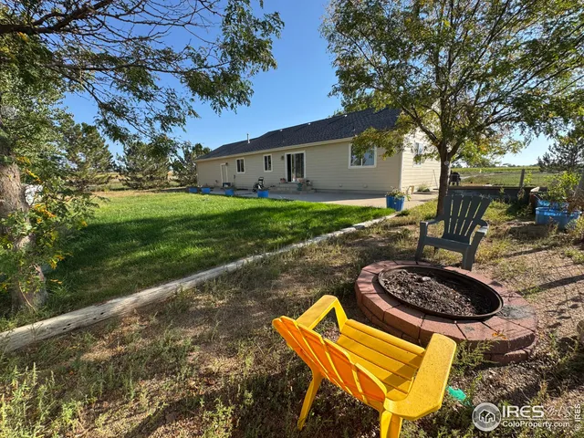 a view of a backyard with plants and a patio