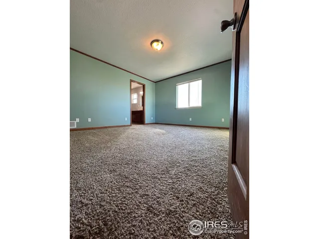 a view of a hallway with window and a livingroom