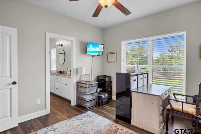 a spacious bathroom with a granite countertop sink a mirror and a shower