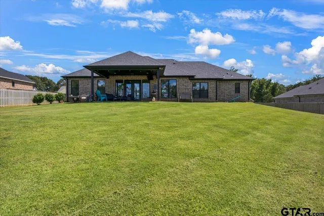 a view of a chair and table in backyard