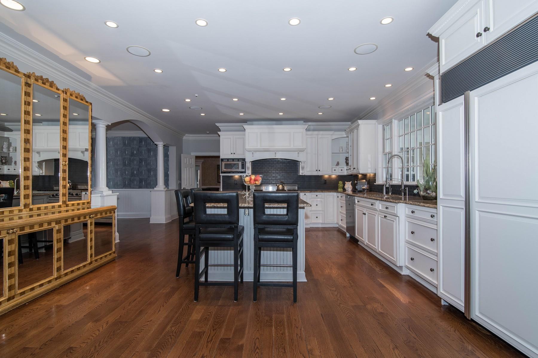 38 Pembroke Road Darien, CT 06820 - Photo 12 of 41 a kitchen with stainless steel appliances kitchen island wooden floors and white cabinets