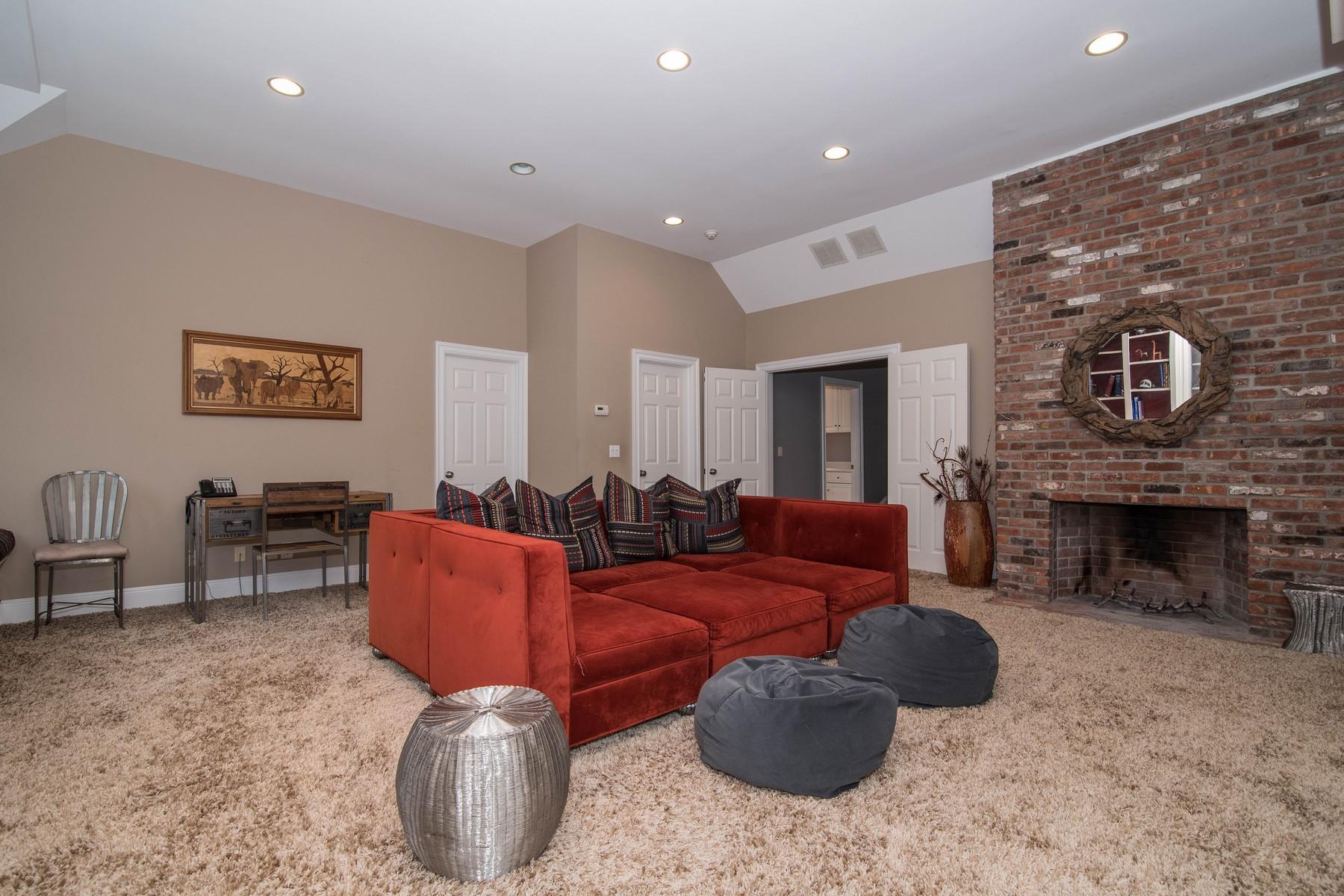 38 Pembroke Road Darien, CT 06820 - Photo 25 of 41 a living room with furniture rug and a fireplace