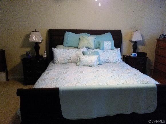 5431 Hackney Road Richmond, VA 23234 - Photo 8 of 17 a large bed sitting in a bedroom next to a lamp